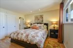 The Master Bedroom is spacious with a king-size bed. a large flat-screen TV and a private bathroom.